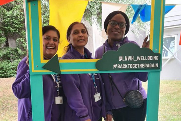 Charity staff in a selfie frame