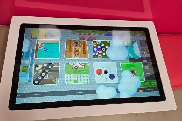 A touch screen table showing lots of different games to choose from.