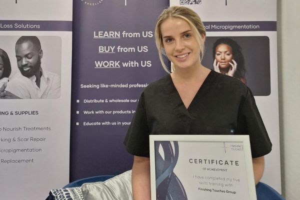 Abbey holding up her certificate.
