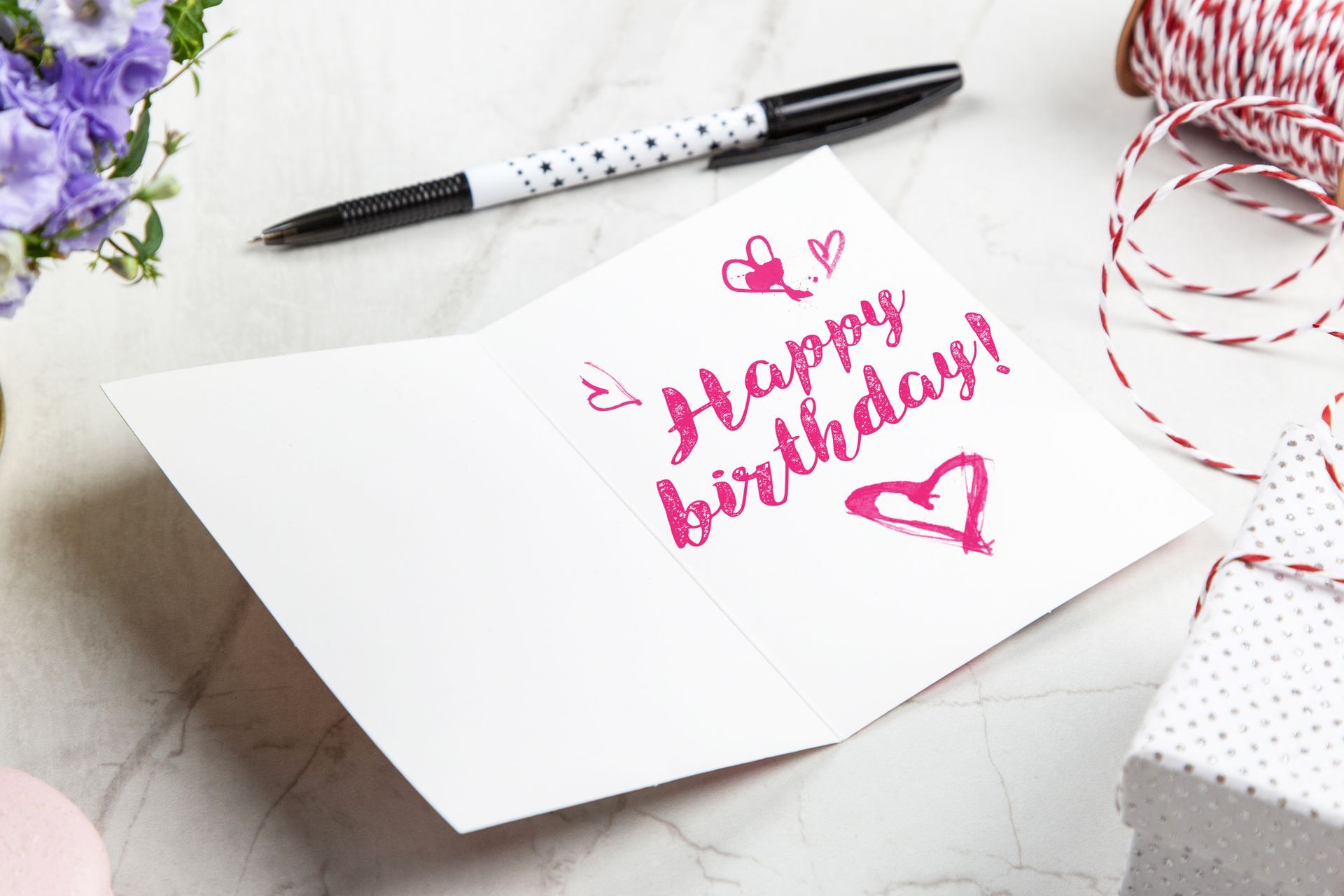 A card on a table that says happy birthday.